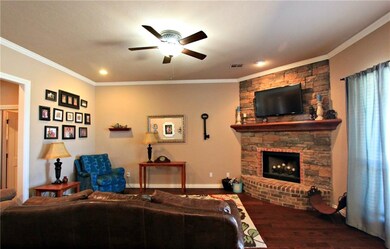 Living Room has Corner Fireplace, Wood Flooring & 