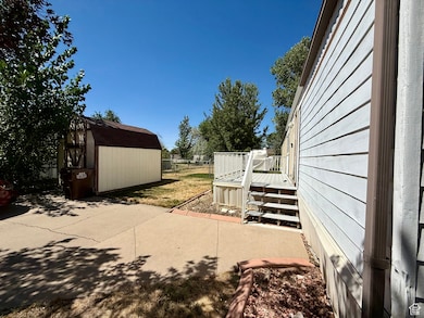 View of patio / terrace with a storage shed and a deck