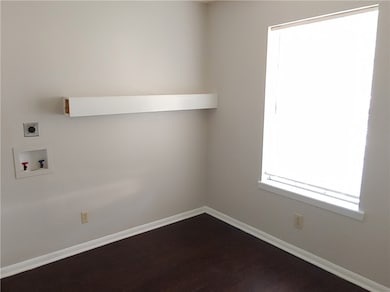 Clothes washing area with laundry area, baseboards
