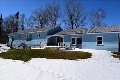 Deck overlooks large backyard with...