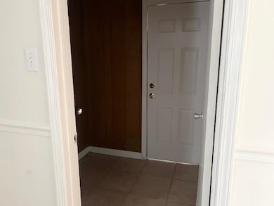 Hallway with tile patterned flooring
