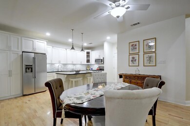 Dining room with light wood-style flooring, reces