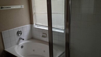 Whirlpool tub with separate shower.