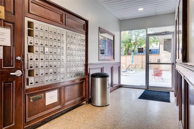 Doorway to outside featuring mail area, wainscoti