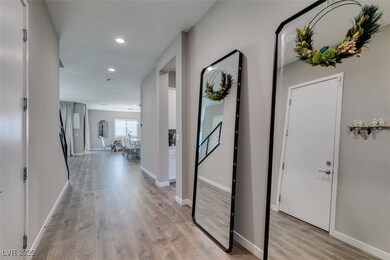 Corridor with light wood-style floors and recessed lighting