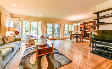 Sun-drenched living room open to the gracious dini
