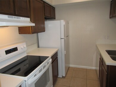 New range, refrigerator, and quartz countertops.