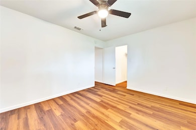 Unfurnished room with baseboards, light wood-type
