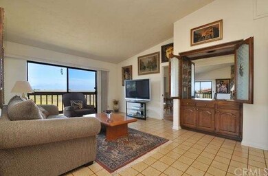 Large family room with a wet bar opens to deck wit