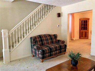 A wide doorway leads to the spacious dining room.