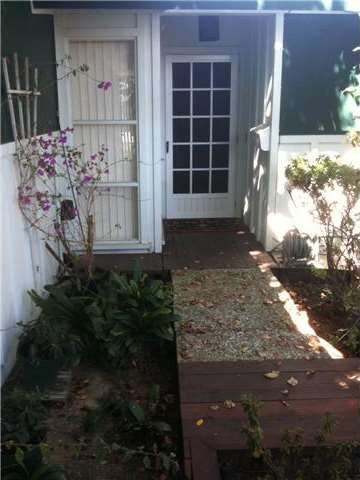 Pathway to front door.  Wood screen door lets ligh