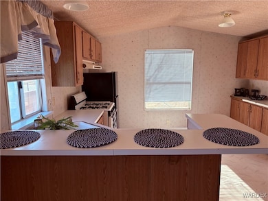 Kitchen with white gas range, kitchen peninsula, a