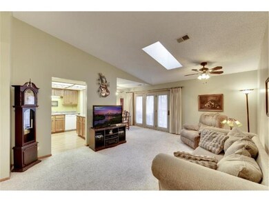 Living area has vaulted ceiling and skylight to br