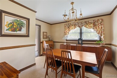 Dining Room featuring carpet floors, a chandelier,