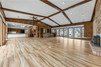 Unfurnished living room with beamed ceiling, wood
