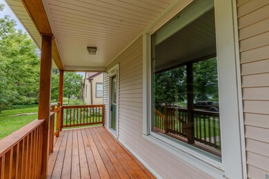 Wooden porch featuring a yard