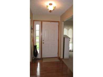 The foyer entryway with hardwood floors is a nice introduction to the home from the covered front porch.