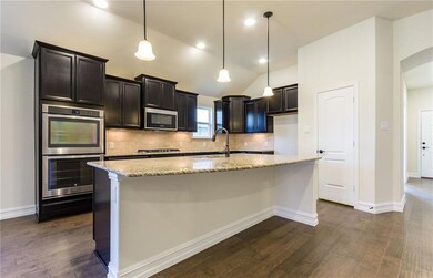 Staggered upper cabinets and double oven in kitche