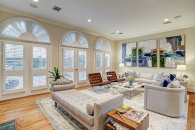 A wall of palladian windows allow glorious sunlight to illuminate the space.  At the center is a set of French doors that lead to...