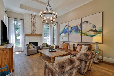 Living room featuring brick wall, wood-type floori