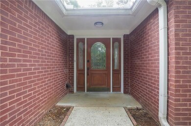 Property entrance featuring brick siding