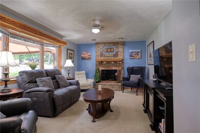 Family room is bathed in natural light and the log