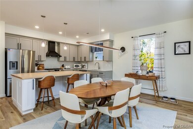 Dining area featuring sink and light wood-type flo