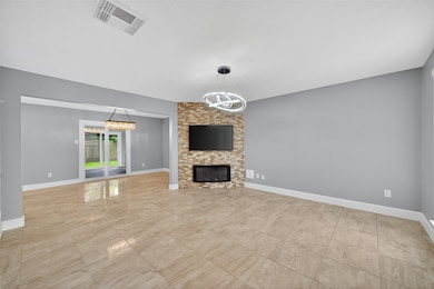 Spacious living room with floor-to-ceiling tile, b
