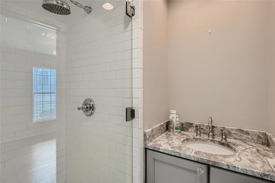 Full bathroom featuring a shower stall and vanity