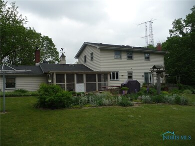 Exterior rear showing large screened-in porch.