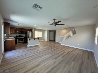 Unfurnished living room featuring ceiling fan, bas