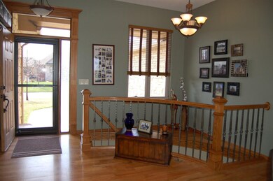 The lovely foyer features hardwood floors and a st