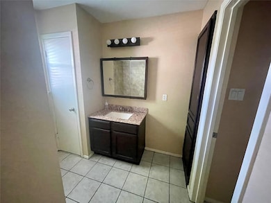 Bathroom with vanity, tile patterned floors, and 