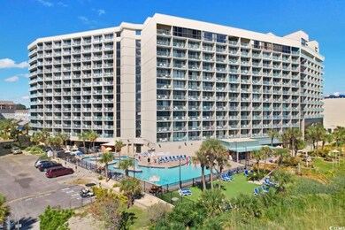 View of building exterior with a community pool