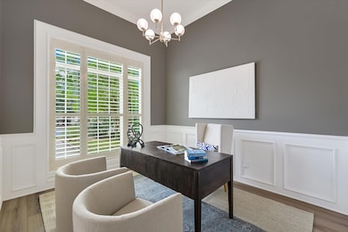 Office featuring a decorative wall, wood finished