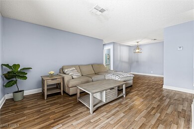 Living room featuring wood laminate floors, clean
