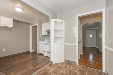 Kitchen featuring range, white cabinets, and dark 