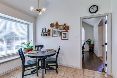 Dining space with lofted ceiling, an inviting chan