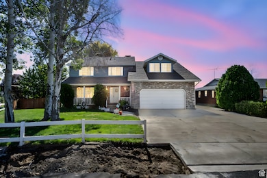 Traditional-style house with driveway, a fenced front yard, and roof with shingles