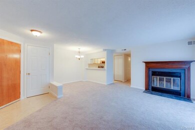 Living room with wood burning fireplace open to di