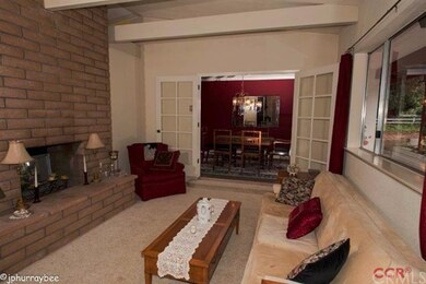 Step down living room with fireplace and French do