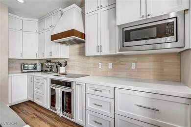 The heart of the home features a stunning chef’s kitchen with quartz countertops, sleek stainless steel appliances, and a spacious island with seating—perfect for entertaining or casual meals.