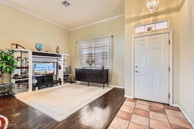Foyer entrance featuring ornamental molding, wood