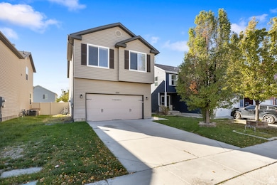 Traditional-style house featuring concrete driveway and an attached garage