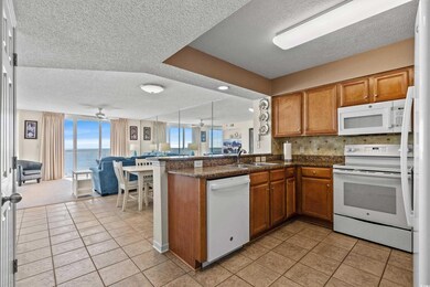 Kitchen featuring brown cabinets, a water view, op