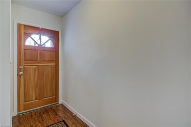 From the front door, you enter the foyer with engineered hardwood floors extending through living areas.