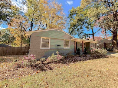 View of front facade with brick siding, crawl space, and covered porch