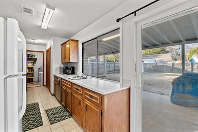 Kitchen with light tile patterned flooring, sink, 