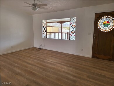 Entryway featuring baseboards, wood finished floor