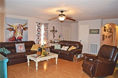 Large living area is open to dining, with laminate